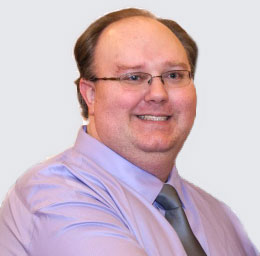 Eric Brockway, Lead Developer for Brukenet Web Development Photo of Eric Brockway, Lead Developer for Brukenet Web Development. He is dressed in a lavander dress shirt and silver tie. He is clean-shaven, has short hair, and wears glasses.